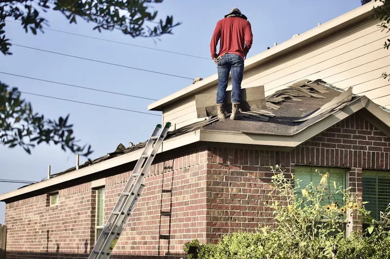 Professional roofer working on a residential roof in Indian Hills